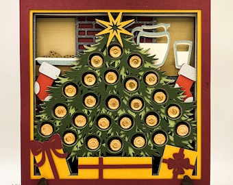 May include: A 3D layered Christmas tree advent calendar with a red, yellow, and green color scheme. The tree is decorated with gold circles and has a star on top. There are two presents at the bottom of the tree.