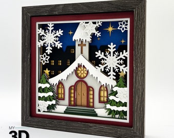 May include: A 3D papercraft scene of a church with a snowy roof and a cross on top. The church is surrounded by trees and snowflakes. The scene is set against a blue night sky with stars.