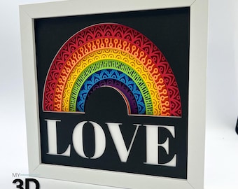 May include: A white frame with a black background featuring a rainbow-colored mandala design with the word "LOVE" in white lettering.