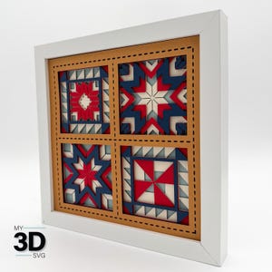 May include: A framed, layered wood art piece featuring four geometric quilt block designs in red, white, and blue. The artwork is set within a white frame and has a brown inner border with stitched details. The text "MY 3D SVG" is in the lower left corner.