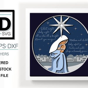 May include: A layered papercraft design of the nativity scene with Mary holding baby Jesus. The design features a blue and white color scheme with a silver star and the text "Silent night holy night all is calm all is bright Round you virgin Mother and child holy infant so tender and mild sleep in heavenly peace".
