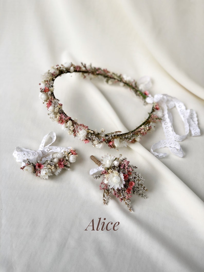 May include: A set of three dried flower arrangements, including a crown, a bracelet, and a boutonniere. The flowers are mainly white and pink, with some brown stems. The text "Alice" is written in the centre of the image.