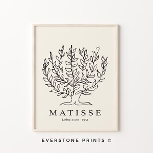 May include: Black and white line art print of a tree with the text "MATISSE Lebuisson - 1951" below the image. The print is framed in a light wood frame.