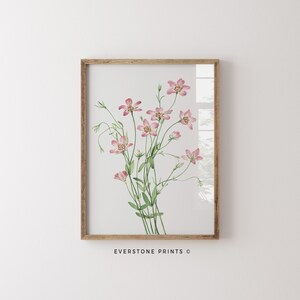 May include: A framed watercolor print of a bouquet of pink flowers with green stems and leaves. The print has a white background and is framed in a light brown wood frame. The text "EVERSTONE PRINTS &copy;" is printed below the image.
