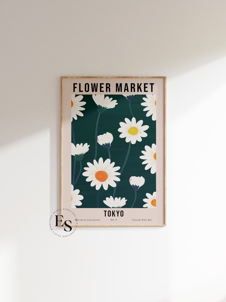 May include: A poster with a green background and white daisies with orange centers. The poster has the text "FLOWER MARKET" at the top and "TOKYO" at the bottom.
