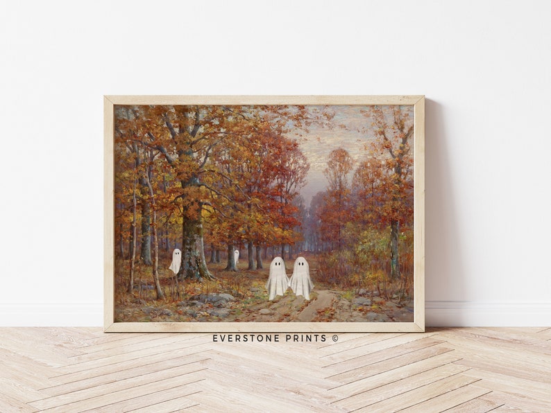 May include: A vintage painting of a forest scene with fall foliage in shades of red, orange, and yellow. Three white ghosts are walking on a path in the woods. The painting is framed in a light wood frame. EVERSTONE PRINTS &copy;