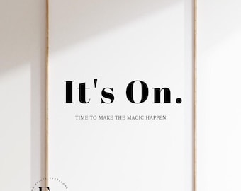 May include: A framed print with the text "It's On. Time to make the magic happen." in black bold font on a white background.
