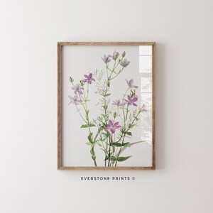 May include: A framed watercolor painting of a bouquet of delicate purple wildflowers with green stems and leaves on a white background. The text "EVERSTONE PRINTS &copy;" is at the bottom of the image.