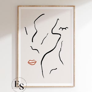 May include: Abstract line art print of a face with a closed eye and red lips on a beige background.