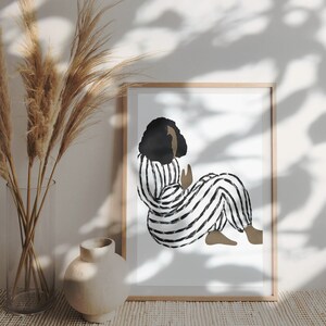 May include: A black and white striped illustration of a person sitting with their legs crossed. The person has dark hair and is wearing a striped jumpsuit.