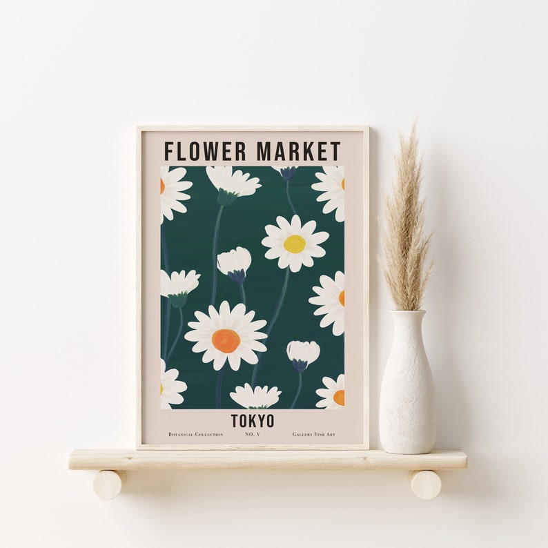 May include: A framed print with a floral design featuring white daisies with yellow centers on a dark green background. The print has the text "FLOWER MARKET TOKYO" at the top and "Botanical Collection No. V Gallery Fine Art" at the bottom.