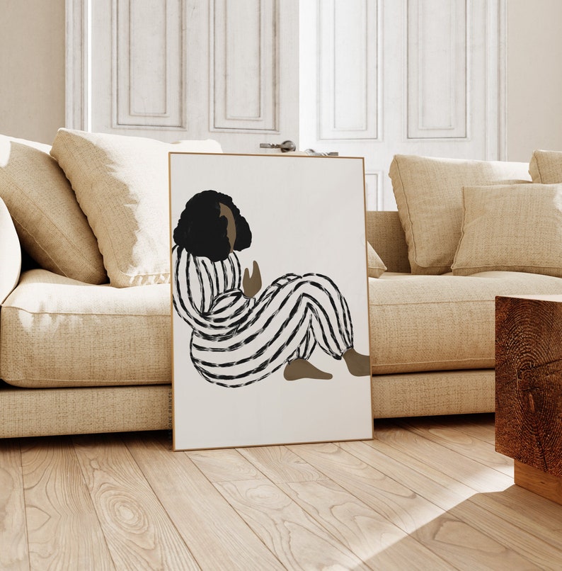 May include: A digital illustration of a person with dark skin and black hair wearing a black and white striped jumpsuit. The person is sitting with their legs crossed and their hands in their lap.