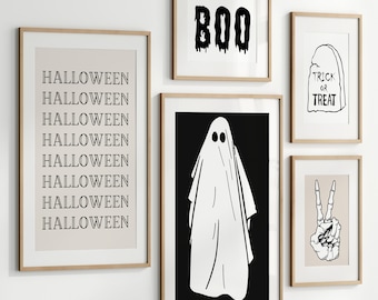 May include: Set of eight Halloween-themed printable wall art prints in black and white. The prints feature a ghost, a tombstone with the words "Trick or Treat", a hand with a peace sign, and the word "BOO" in dripping letters. One print features the word "Halloween" repeated eight times.
