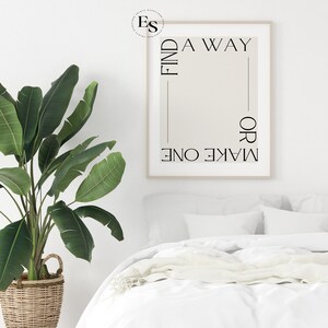 May include: A white framed print with the text "FIND A WAY OR MAKE ONE" in black lettering on a beige background.