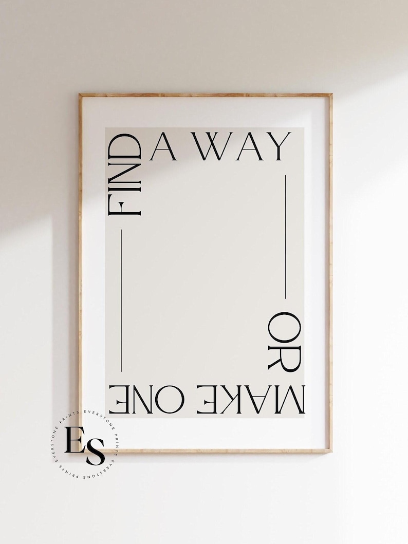 May include: A framed print with the text "FIND A WAY OR MAKE ONE" in a minimalist black font on a light beige background.