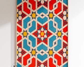 May include: A framed print of a geometric pattern in red, blue, yellow, and white. The pattern is made up of repeating shapes and lines, creating a complex and intricate design.