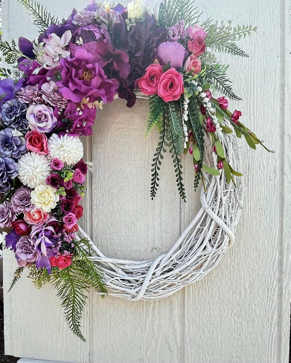 Trendy Spring or Summer Wreath, full of real-touch flowers, on a white 18inch grapevine wreath.