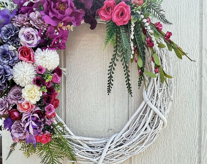 Trendy Spring or Summer Wreath, full of real-touch flowers, on a white 18inch grapevine wreath.