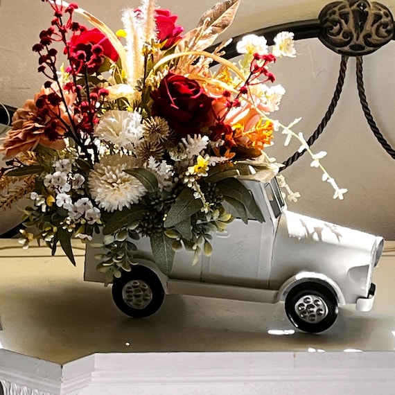 Vintage white metal truck filled with seasonal florals/red roses wildflowers