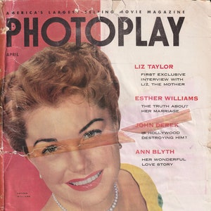 May include: A vintage magazine cover featuring a close-up portrait of a woman with red lipstick and a pearl necklace. The magazine is titled "PHOTOPLAY" and the cover features the names Liz Taylor, Esther Williams, John Derek, and Ann Blyth.