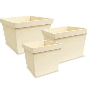 May include: Three cream-coloured, square planters of varying sizes. Each planter has a rectangular opening and a slightly flared, trapezoidal shape. The planters are made of a light-coloured material and are set against a white background.