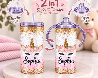 May include: A 2-in-1 sippy cup and tumbler featuring a gold glitter and pink gradient design with a unicorn face graphic and the name Sophia. It includes a clear straw lid and a purple sippy lid with handles, labeled 2 in 1 Sippy to Tumbler.