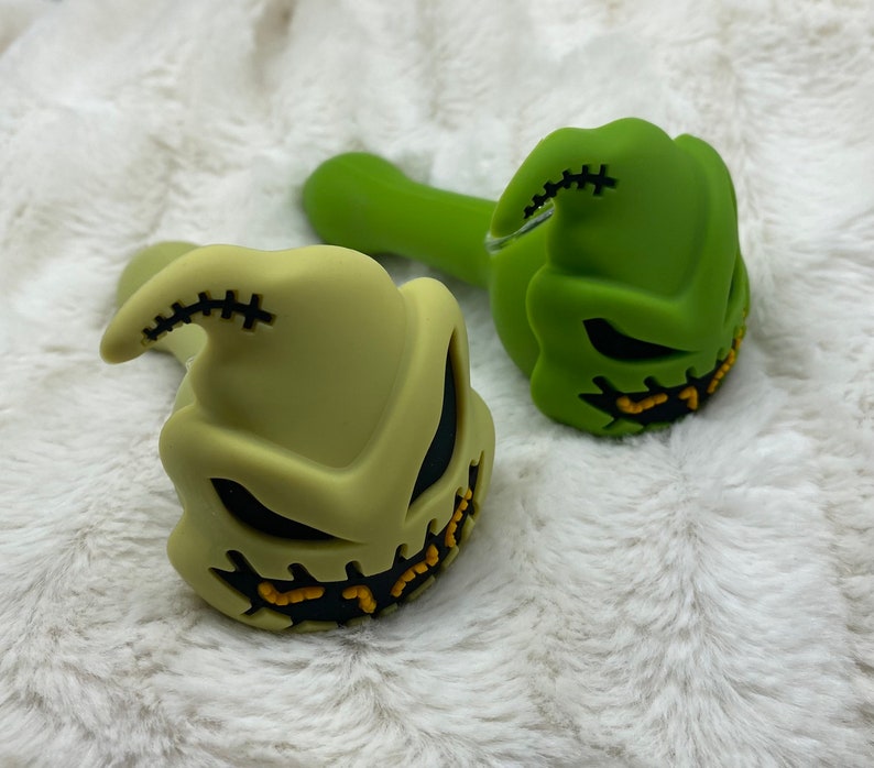 May include: Two silicone pipes shaped like the character Jack Skellington from the movie The Nightmare Before Christmas. One pipe is green and the other is a light green color.