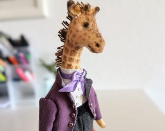 Textile interior giraffe doll, vintage-style miniature on a stand, in a purple tailcoat, a gentleman giraffe.