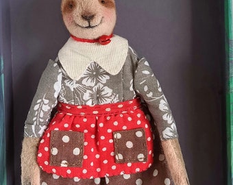 A sloth, a vintage-style textile doll, interior toy on a stand.