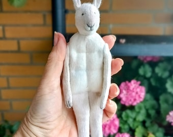 A white rabbit on a stand. Textile interior doll.