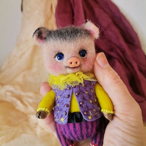 A small pig, a soft toy made of wool, an interior toy in vintage style, a beast doll for a collection, for a gift.