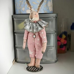 Textile teddy rabbit doll in vintage style, interior toy on a stand, a gift for women.