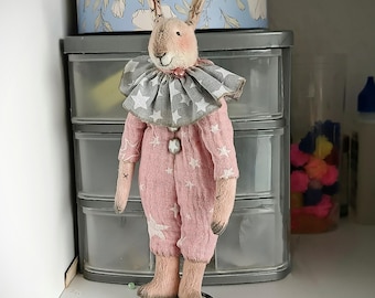 Textile teddy rabbit doll in vintage style, interior toy on a stand, a gift for women.