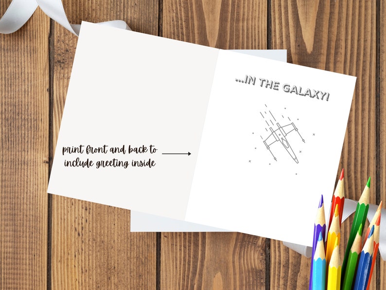 May include: A blank card with a black and white illustration of a spaceship flying through space. The text on the card reads "...IN THE GALAXY!"