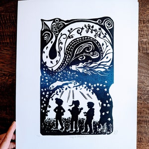 May include: A black and white linocut print of three children standing under a tree with a dragon in the branches above them. The print is titled "Imagine Dragons II".