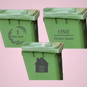May include: Three green trash bins with different address number designs. One bin has the number 1 inside a house silhouette, another has the number 1 inside a wreath, and the third has the word "ONE". All bins have the text "Terrace Square".