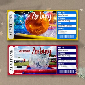 May include: Two red and yellow printable admission tickets for a zorbing experience. The tickets have the text "You're Going Zorbing" and "Admit One". The tickets have space to write in the name of the recipient, the destination, the date, and a message.