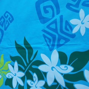 May include: A blue fabric with a white floral pattern and blue geometric designs. The fabric has a tropical theme.