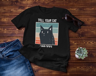 May include: Black t-shirt with a vintage-style graphic of a black cat and the text "TELL YOUR CAT I SAID PSSPSPS".