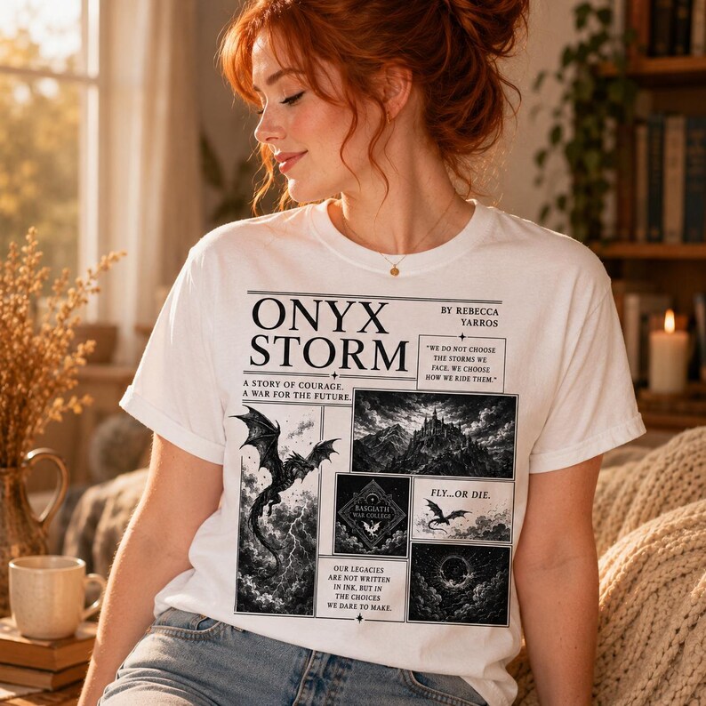 May include: White t-shirt featuring the text "ONYX STORM" with a graphic of a dragon and other imagery. The shirt also includes the text "A STORY OF COURAGE. A WAR FOR THE FUTURE" and "FLY...OR DIE".