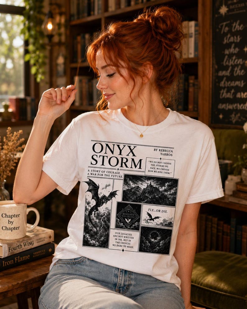 May include: White t-shirt featuring a black and white graphic design with the text "ONYX STORM" and illustrations of dragons and landscapes. The shirt also has the text "Chapter by Chapter" on a mug.