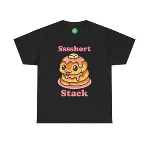 May include: Black t-shirt featuring a cartoon stack of pancakes with a cute face, butter, and syrup. The text "Sssshort Stack" is above the pancakes, and "Stack" is below. The design is in pink and tan.