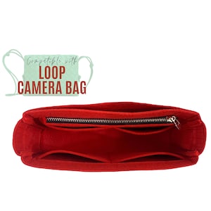 May include: Red felt camera insert with multiple compartments and a zipper closure. Compatible with Loop Camera Bag.