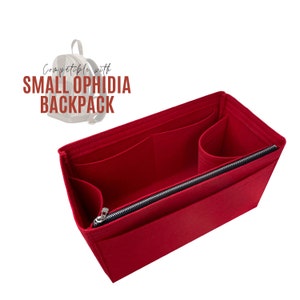 May include: Red felt bag organizer with multiple compartments and a zippered pocket. Compatible with Small Ophidia Backpack.