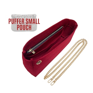 May include: Red felt bag insert with a zipper closure and a gold chain strap. The insert is compatible with the "Puffer Small Pouch".