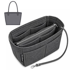 May include: A dark gray felt handbag organizer insert featuring multiple interior compartments, a central zippered pocket with a silver-toned metal zipper, and an attached strap with a silver-toned metal lobster clasp. A small black tag reads Divitize.