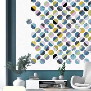 May include: A white wall art piece featuring a pattern of colorful, overlapping circles in various sizes and designs. The circles are in shades of blue, yellow, pink, and black. The text "DOTS ON POINT" is visible.