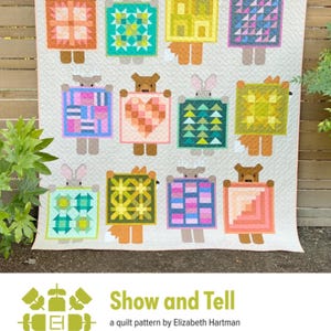 May include: A handmade quilt featuring whimsical animal figures holding colorful patchwork squares. The quilt showcases a variety of geometric patterns and vibrant colors, including orange, teal, pink, and yellow. The text "Show and Tell" is visible at the bottom.