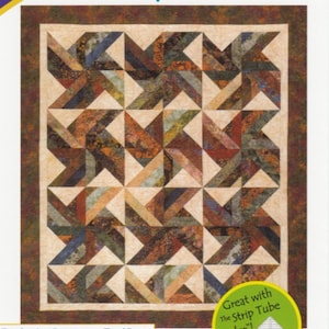 May include: A quilt pattern called "Tradewinds" designed by Georgette Dell'Orco. The pattern is for a quilt made with 2 1/2 inch strips and includes instructions for wall hanging, throw, twin, queen, and king sizes. The quilt features a geometric design with brown, beige, and cream colors.