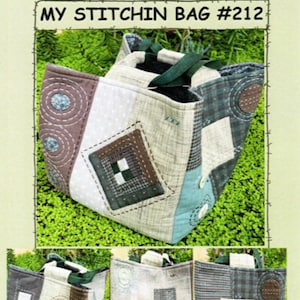 May include: A patchwork tote bag with a green strap. The bag is made of different fabrics with various patterns, including circles, squares, and plaid. The bag is sitting on a bed of green moss. The text "SUZANNE'S ART HOUSE MY STITCHIN BAG #212" is printed on the top of the image.